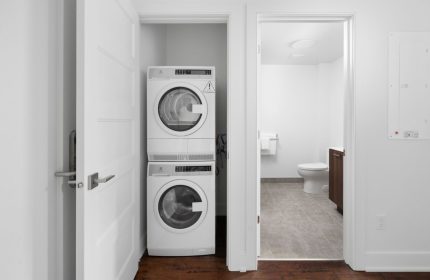 Sonder Gare Saint Denis: Washer and dryer in a closet. Bathroom visible through doorway. Gay-friendly hotel with modern amenities.