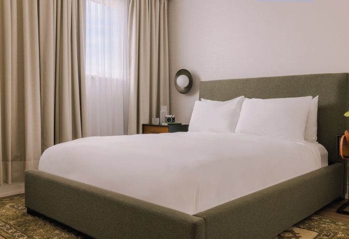 Sonder The Sunset gay-friendly hotel room. Modern design with a plush bed, neutral tones, and ambient lighting. Ideal for gay travel.