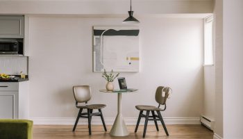 Sonder The Sunset gay-friendly hotel room. Dining table with laptop, chairs, and modern art. A comfortable space for gay travelers.