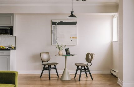Sonder The Sunset gay-friendly hotel room. Dining table with laptop, chairs, and modern art. A comfortable space for gay travelers.