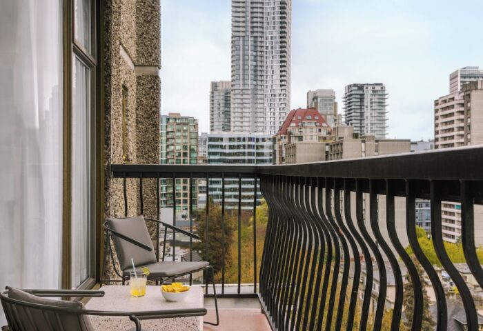 Balcony view from Sonder The Sunset, a gay-friendly hotel. Drinks, chairs, and city skyline. Ideal for gay travel and relaxation.