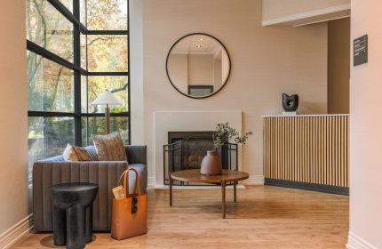 Sonder The Sunset lobby interior. Gay-friendly hotel with modern design, fireplace, seating area, and large windows. A comfortable, stylish space.