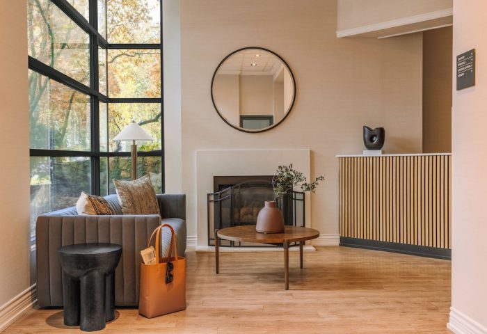 Sonder The Sunset lobby interior. Gay-friendly hotel with modern design, fireplace, seating area, and large windows. A comfortable, stylish space.