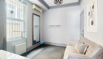 Sonder The Wellesley gay-friendly hotel room. Interior view with sofa, mirror, and shower. Modern design for gay travelers.