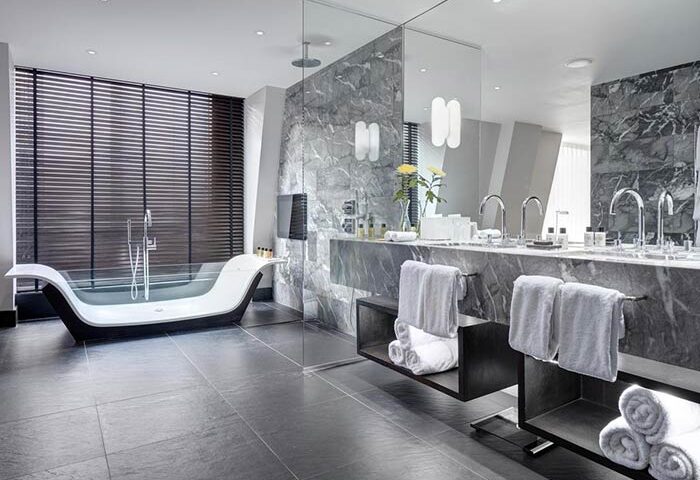 South Place Hotel bathroom. Pet-friendly, gay-friendly hotel with modern bathtub, marble accents, and sleek design. Luxury travel.