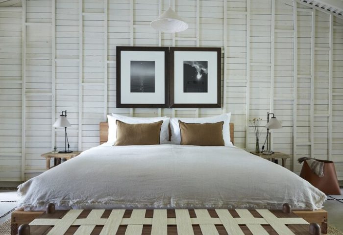 Sparrows Lodge gay-friendly hotel bedroom. White plank walls, modern bed, lamps, & black and white art. A relaxing, stylish retreat.