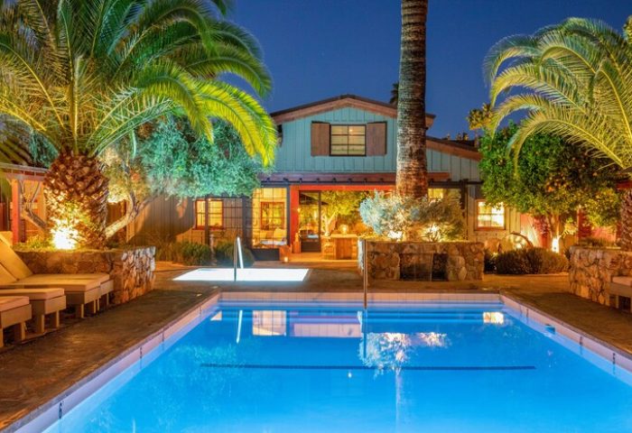 Sparrows Lodge, a gay-friendly hotel. Swimming pool and palm trees at night. A tranquil, romantic travel destination for gay men.