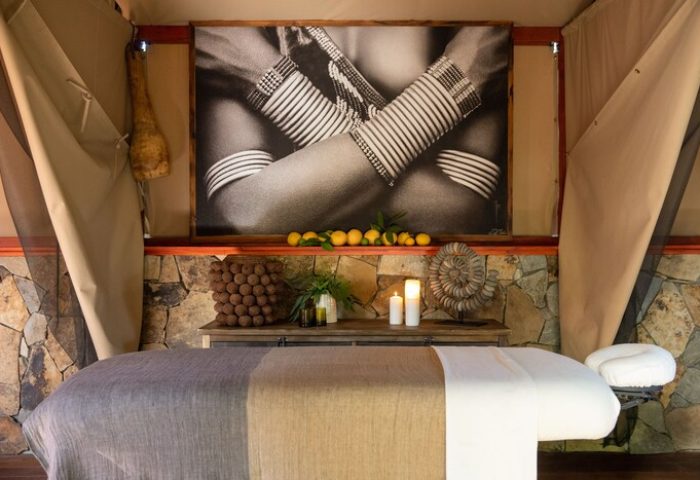 Sparrows Lodge gay-friendly hotel spa room. Massage table, candles, lemons, tribal art. Relaxing, rustic decor for gay men travelers.