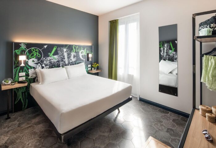 Spice Hotel Milano gay-friendly room. Stylish interior with double bed, chalkboard headboard, and modern decor. Perfect for gay travelers.