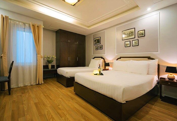 Spring Flower Hotel gay-friendly room with two beds, wood floors, and soft lighting. Ideal for gay men's travel, offering comfort and style.