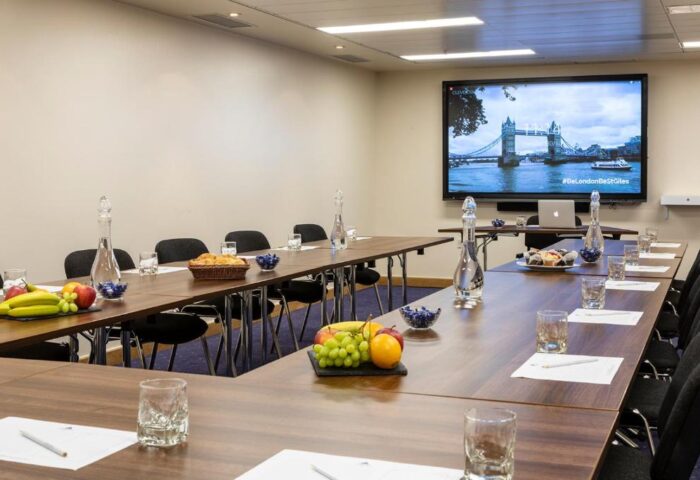 St Giles London Hotel conference room. Meeting space with fruit, water, and view of Tower Bridge. Gay-friendly hotel in London.