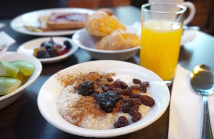 Breakfast at St Giles London Hotel. Oatmeal with raisins, plums and cinnamon. Croissants, toast, fruit, and orange juice. Gay-friendly hotel.