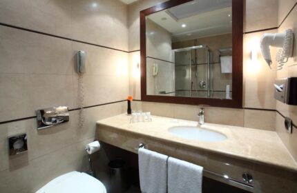 Starhotels Ritz gay-friendly hotel bathroom. Sink, mirror, shower, and toilet. Gay travel-friendly accommodations.