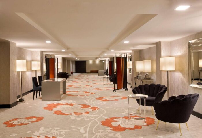 Starhotels Ritz: Hotel lobby featuring floral carpet, stylish seating, and warm lighting. A gay-friendly hotel for your travel needs.