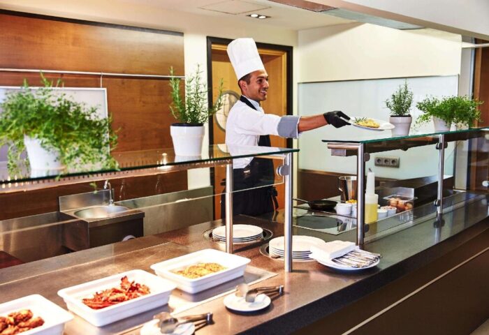 Steigenberger Hotel Köln breakfast buffet. Chef serving food at this gay-friendly hotel in Koln. Fresh, delicious options.