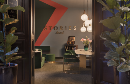 Stories Hotel Budapest lobby view. Gay-friendly hotel interior with modern design, plants, and stylish furniture.