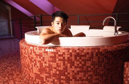 Stories Hotel Budapest gay-friendly: Man relaxing in a tiled jacuzzi. A luxurious experience for gay travelers. Budapest hotel spa.