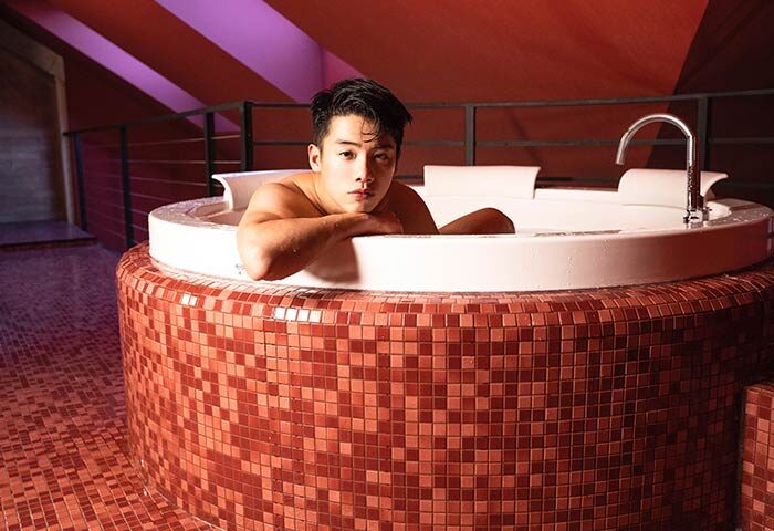 Stories Hotel Budapest gay-friendly: Man relaxing in a tiled jacuzzi. A luxurious experience for gay travelers. Budapest hotel spa.