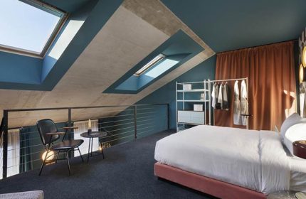 Stories Hotel Budapest gay-friendly room. Loft suite with skylights, bed, seating area. Modern design. Ideal for gay travel in Budapest.