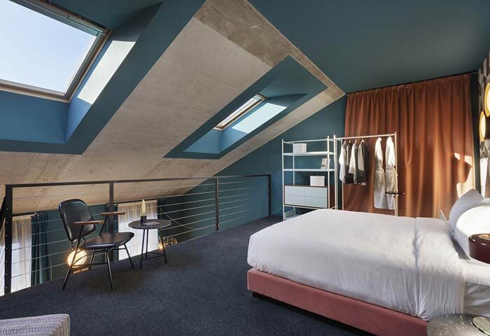 Stories Hotel Budapest gay-friendly room. Loft suite with skylights, bed, seating area. Modern design. Ideal for gay travel in Budapest.