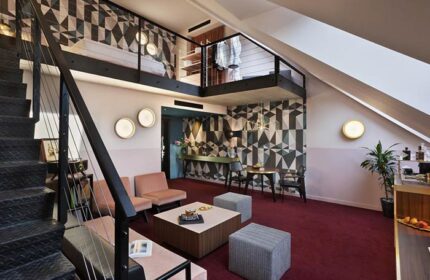 Stories Hotel Budapest room interior. Gay-friendly hotel with loft, geometric wallpaper, & modern design. Ideal for gay men travel in Budapest.