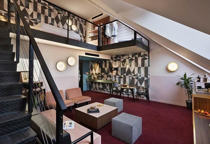 Stories Hotel Budapest room interior. Gay-friendly hotel with loft, geometric wallpaper, & modern design. Ideal for gay men travel in Budapest.