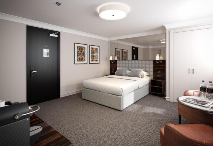 Gay-friendly Strand Palace Hotel bedroom with double bed, ensuite, and modern decor. Ideal for gay travelers visiting London, UK.