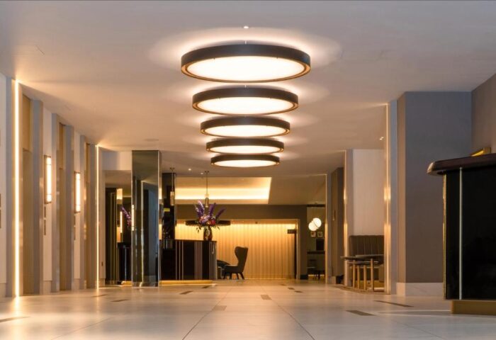 Strand Palace Hotel lobby. Gay-friendly hotel with modern lighting, sleek design, and a welcoming atmosphere for gay travelers.
