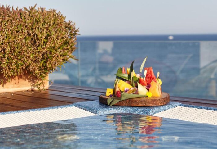 Gay-Friendly Sud Ibiza Suites hotel detail: Fruit platter by the pool. Luxury gay travel at this Ibiza suites hotel.
