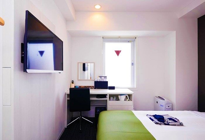 Super Hotel Shinjuku Kabukicho room. Modern, clean interior with TV, desk, and window. Gay-friendly hotel in Tokyo's vibrant district.