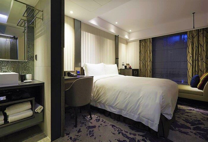 Gay-Friendly TANGO INN TAIPEI XIMEN hotel room. Modern decor, comfortable bed, workspace, and stylish bathroom. Great for gay travelers.