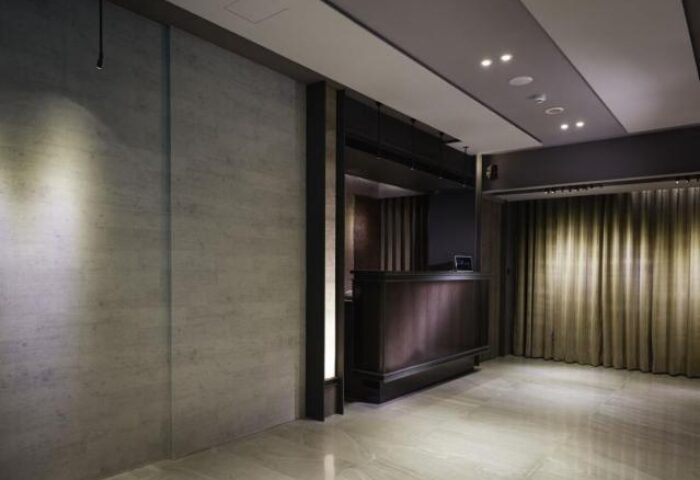 TANGO INN TAIPEI XIMEN lobby. Gay-friendly hotel featuring a modern reception area with dark wood accents and elegant lighting. Taiwan travel.
