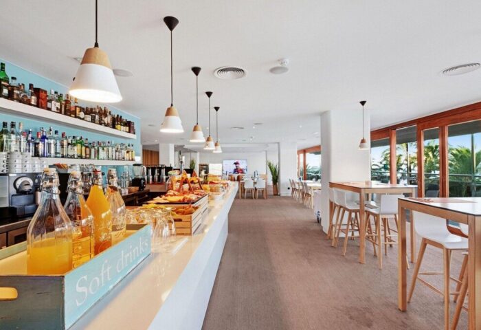THB Los Molinos Adults Only hotel bar. Gay-friendly hotel interior with drinks, food, tables, and chairs. Modern design, bright and inviting.