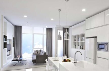 Modern suite at THE FACE Suites Kuala Lumpur, a gay-friendly hotel. Features a sleek kitchen, living area, and city views.
