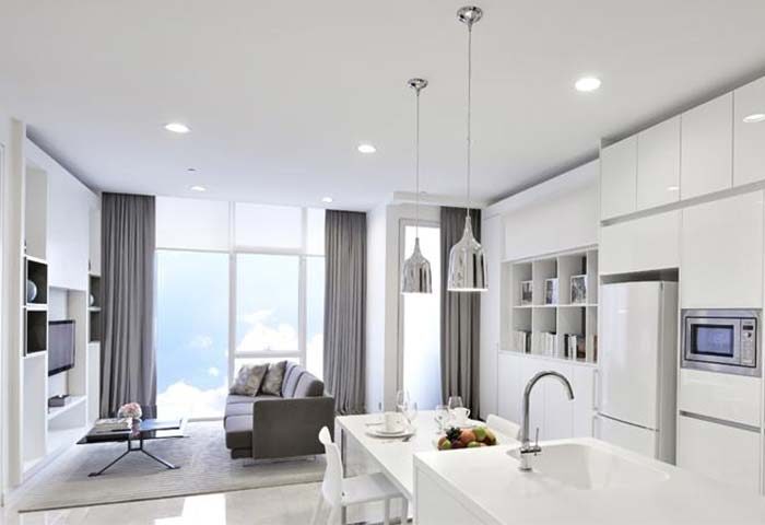 Modern suite at THE FACE Suites Kuala Lumpur, a gay-friendly hotel. Features a sleek kitchen, living area, and city views.