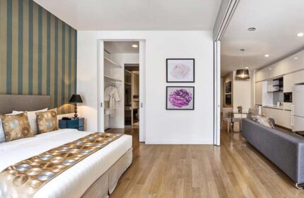 THE FACE Suites Kuala Lumpur room. Gay-friendly hotel with bedroom, living area, and kitchenette. Modern design, wood floors.
