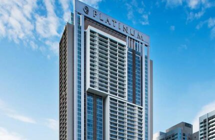 THE FACE Suites Kuala Lumpur, a gay-friendly hotel. Exterior view of the Platinum Suites building against a blue sky.