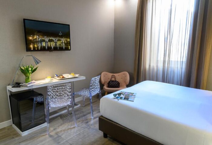Gay-friendly hotel room: bed, desk, TV with Rome view. Travel advice for gay men. The Guardian's recommendation for gay travel.