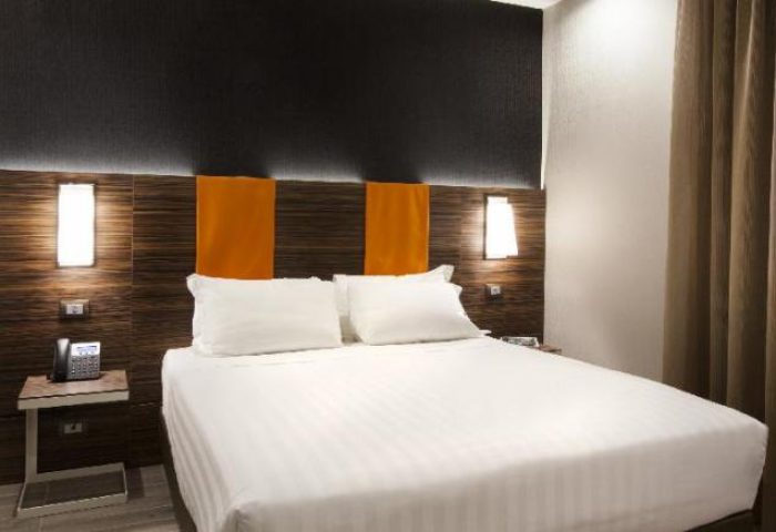 The Republic gay-friendly hotel room. Modern design with a double bed, stylish headboard, and bedside lighting. Comfortable and inviting.