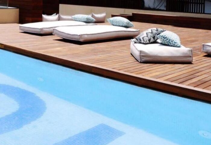 TOC Hostel Barcelona gay-friendly hotel pool area. Relax on the deck's cushions by the water. A great place for gay travelers to stay.