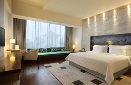 TS Suites Seminyak gay-friendly hotel room. Luxurious bedroom with king bed, desk, and window seat. Great for gay men travelers.