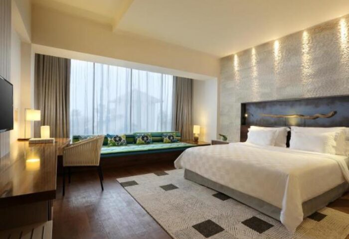 TS Suites Seminyak gay-friendly hotel room. Luxurious bedroom with king bed, desk, and window seat. Great for gay men travelers.