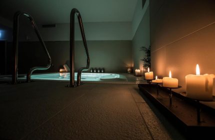 TWO Hotel Berlin by Axel Adults Only spa area. Candles illuminate a jacuzzi with handrails. Gay-friendly hotel detail.