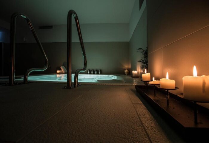 TWO Hotel Berlin by Axel Adults Only spa area. Candles illuminate a jacuzzi with handrails. Gay-friendly hotel detail.