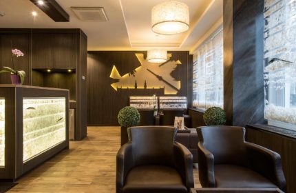TWO Hotel Berlin by Axel lobby. Gay-friendly, adults-only hotel interior. Modern design with chairs, lighting, and Berlin skyline wall art.