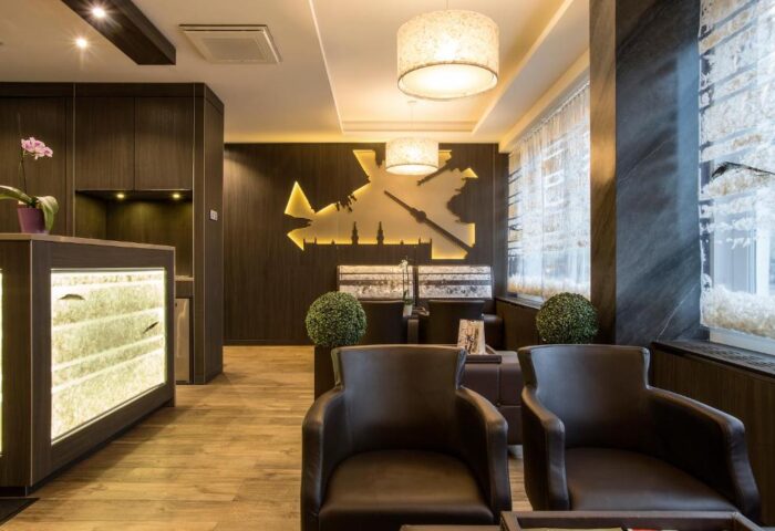 TWO Hotel Berlin by Axel lobby. Gay-friendly, adults-only hotel interior. Modern design with chairs, lighting, and Berlin skyline wall art.