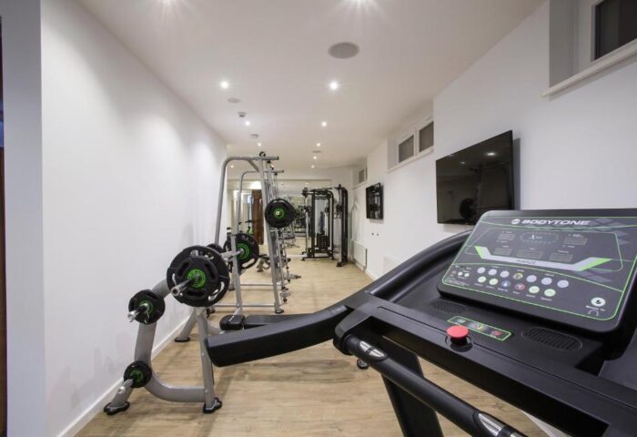 Gym at TWO Hotel Berlin by Axel, an adults-only, gay-friendly hotel. Treadmill and weight machines for guests' fitness needs.