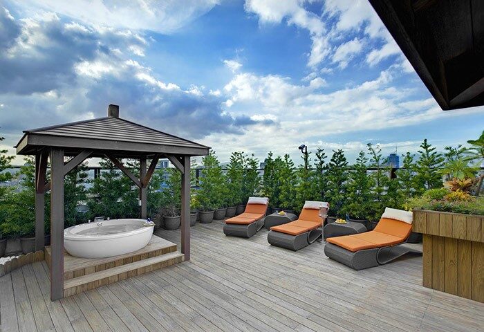 Taipei Garden Hotel's rooftop terrace. Hot tub under gazebo, lounge chairs, and city views. A gay-friendly hotel in Taipei for relaxing getaways.