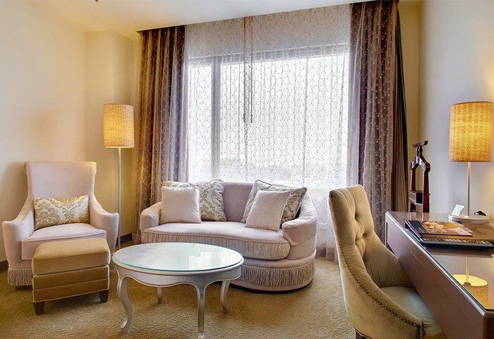 Taipei Garden Hotel's gay-friendly room: A plush chair, sofa, and desk create a welcoming space. Perfect for gay travelers seeking comfort.