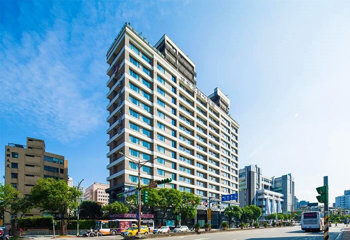 Taipei Garden Hotel exterior view. A gay-friendly hotel in Taipei, Taiwan, with modern architecture and a bustling city street in front.